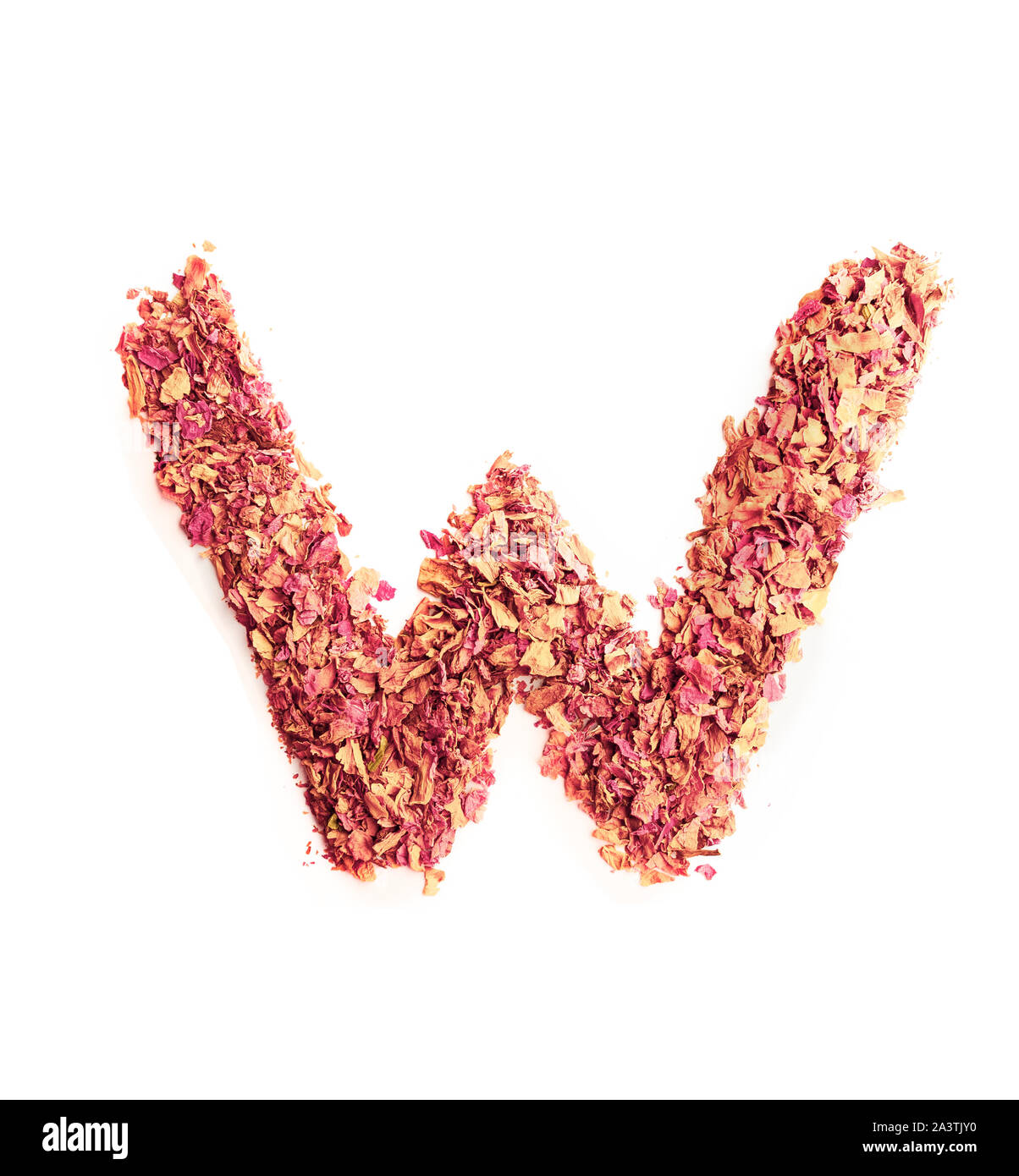 Letter W made of rose petals, isolated on white background. Food typography, english alphabet. Design element. Stock Photo