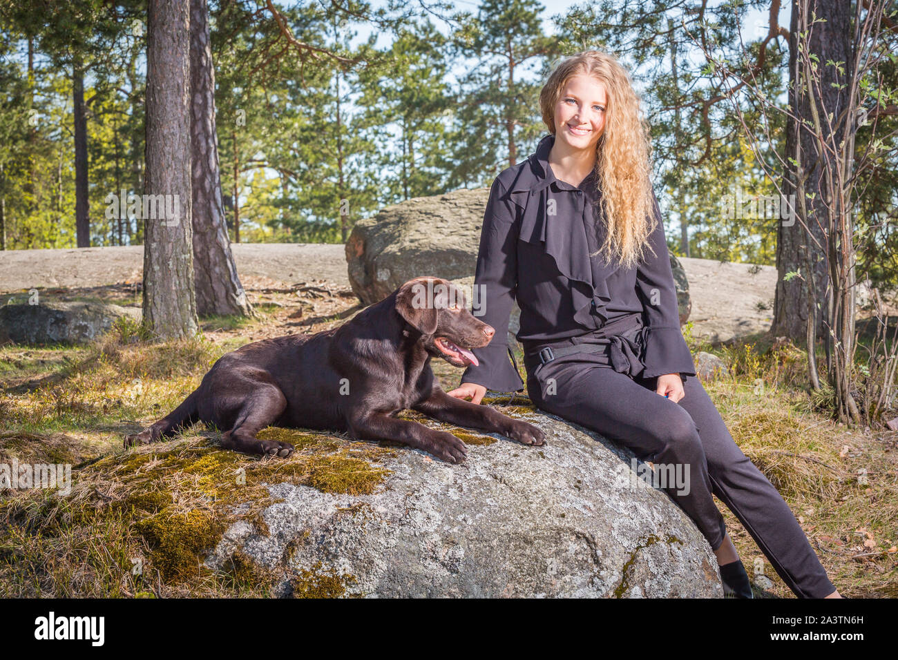 Young woman outdoors with a lovely young labrador retriever puppy Stock ...