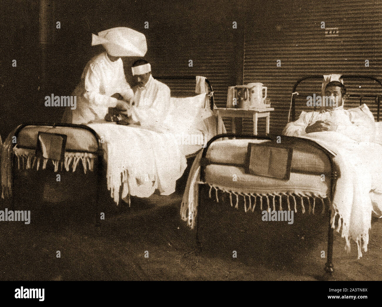WWI - A sister tending wounded  British soldiers at an army hospital near the front in France. Stock Photo