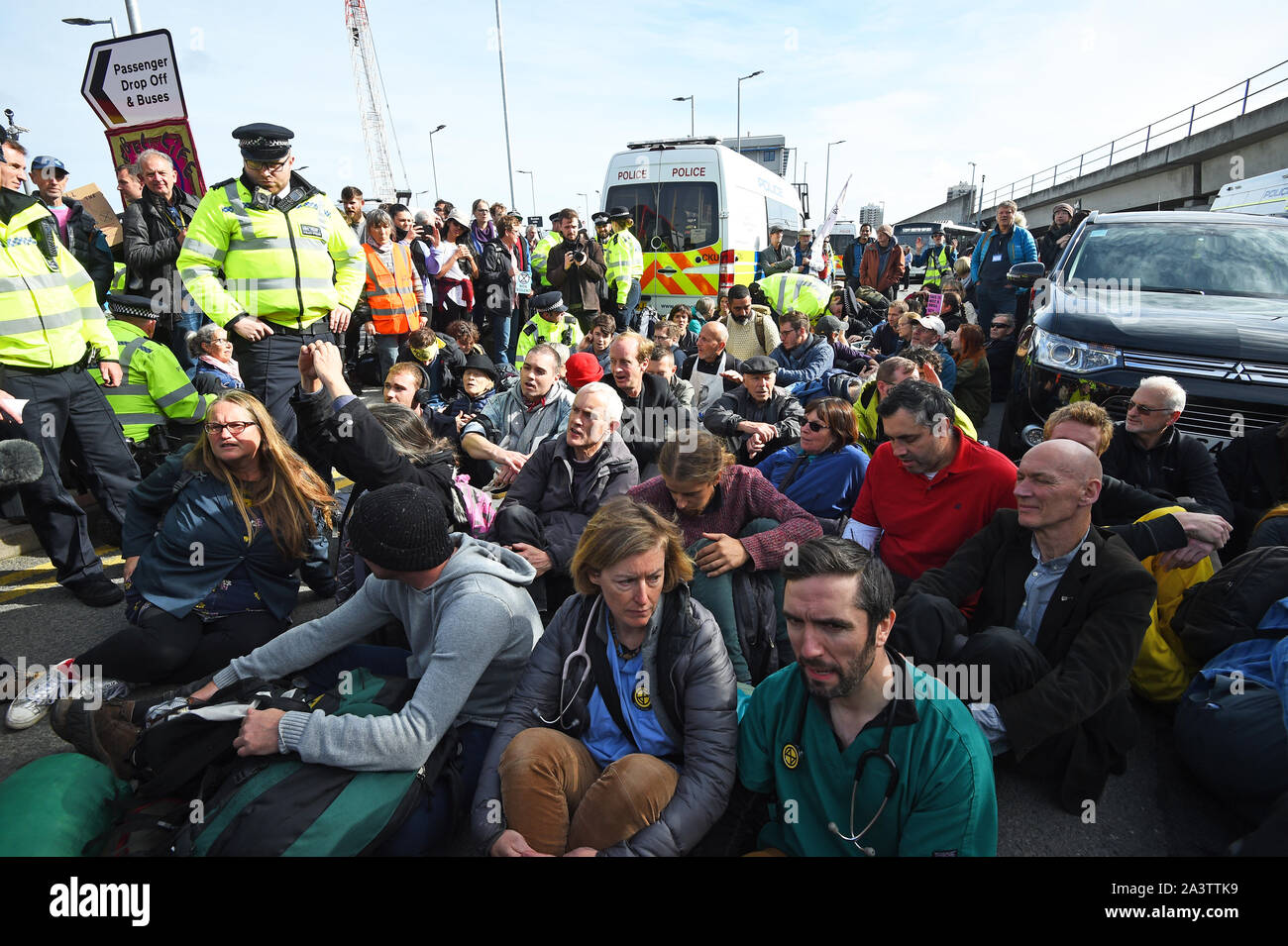 Protesters blocking the road outside City Airport, London, during an Extinction Rebellion climate change protest. Stock Photo