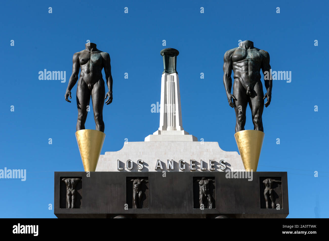 The Olympic Gateway arch and male and female statues at the entrance to