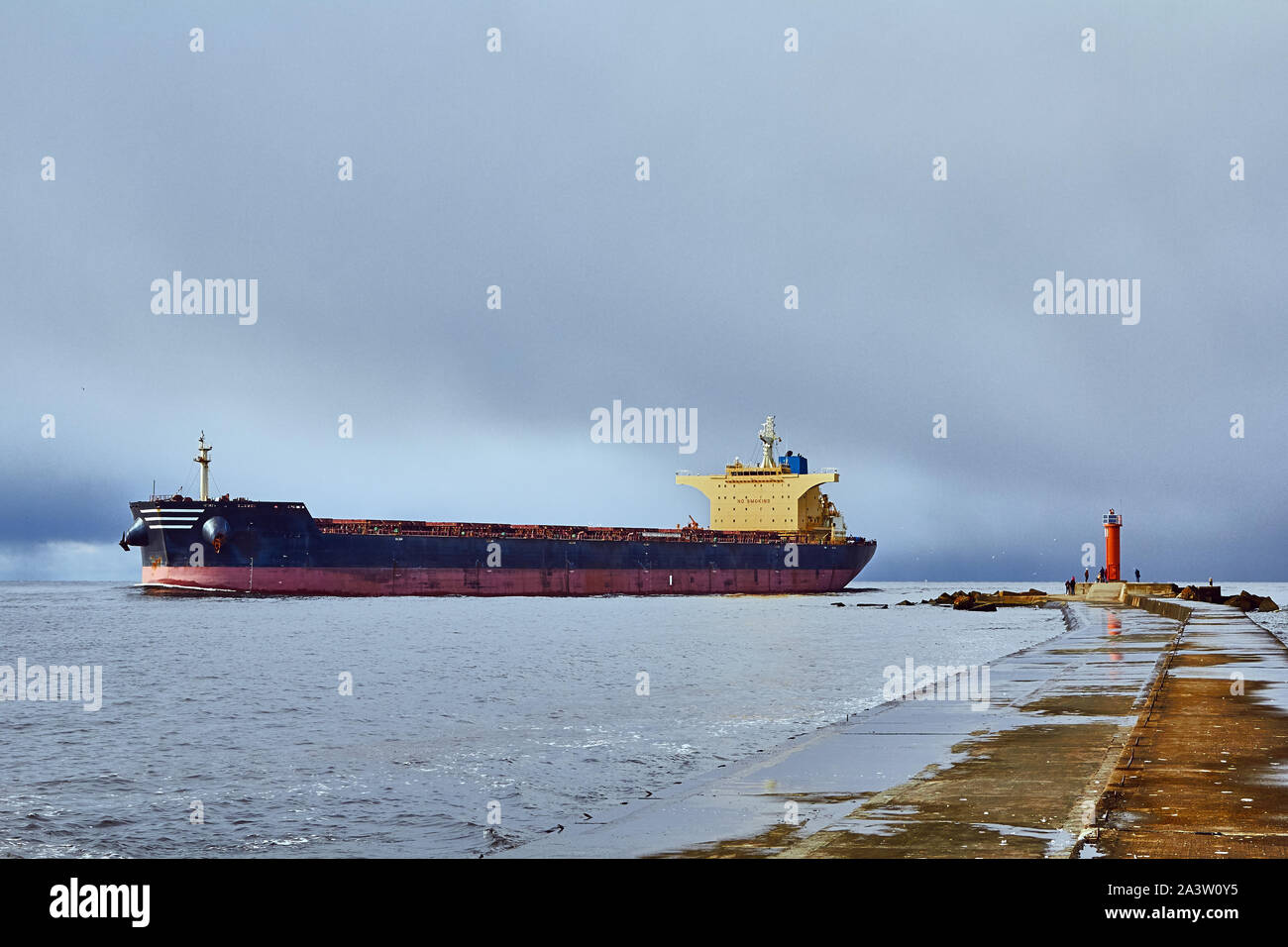 freight ship on windy day going from port in Riga,Latvia, industrial transportation background Stock Photo