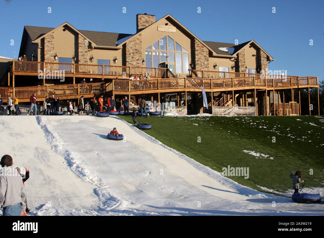 People tubing in front of the BarrickFalwell Lodge at the Liberty