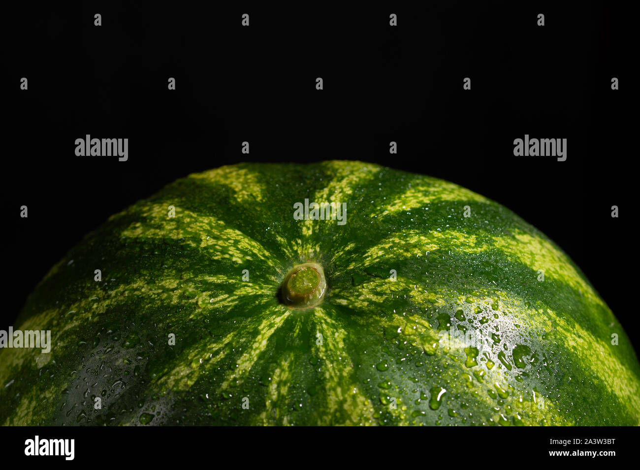 watermelon on black background with water drops Stock Photo