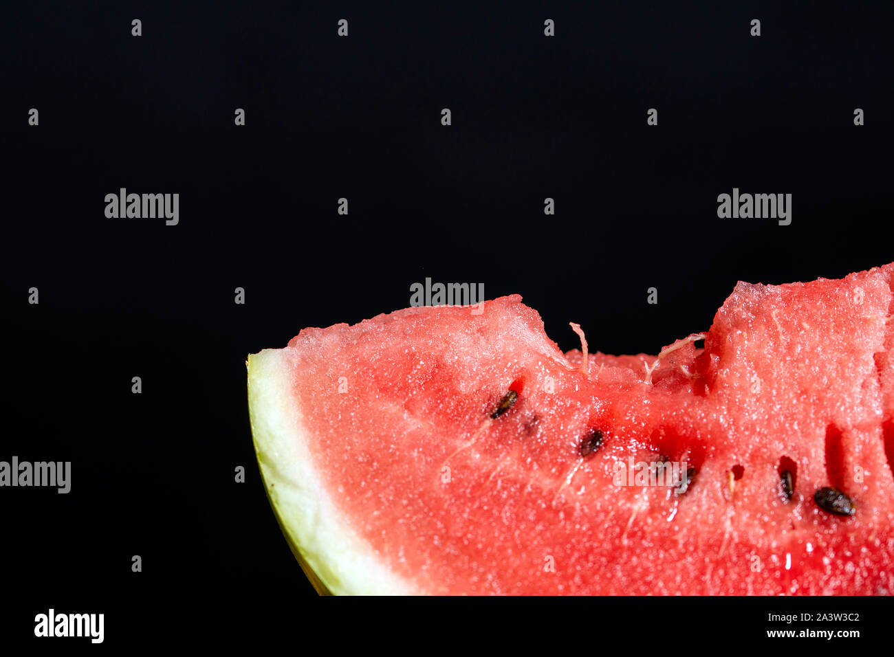 Bit slice of watermelon on black background Stock Photo