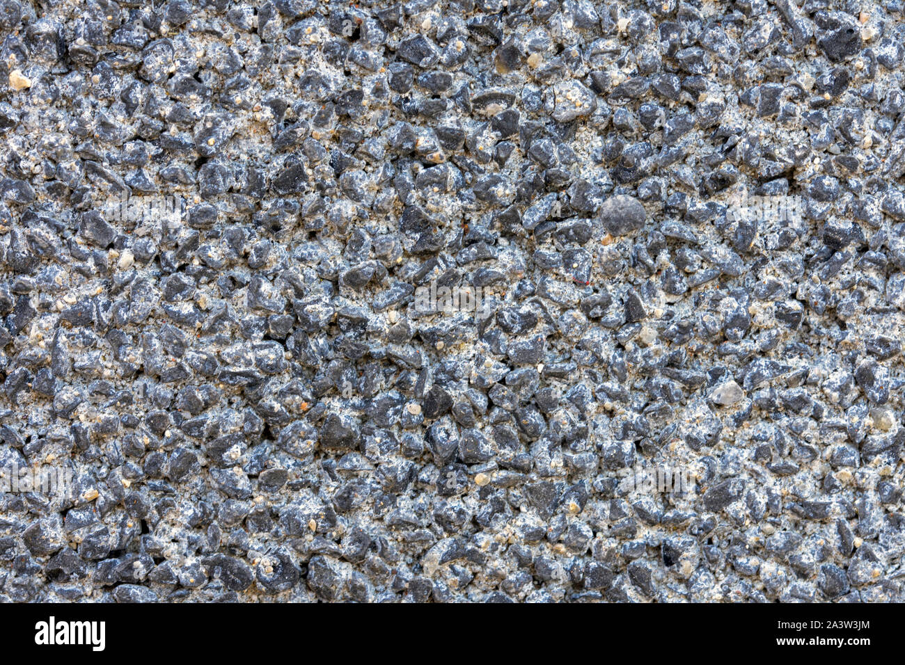 Wall design with small gray stones Stock Photo - Alamy