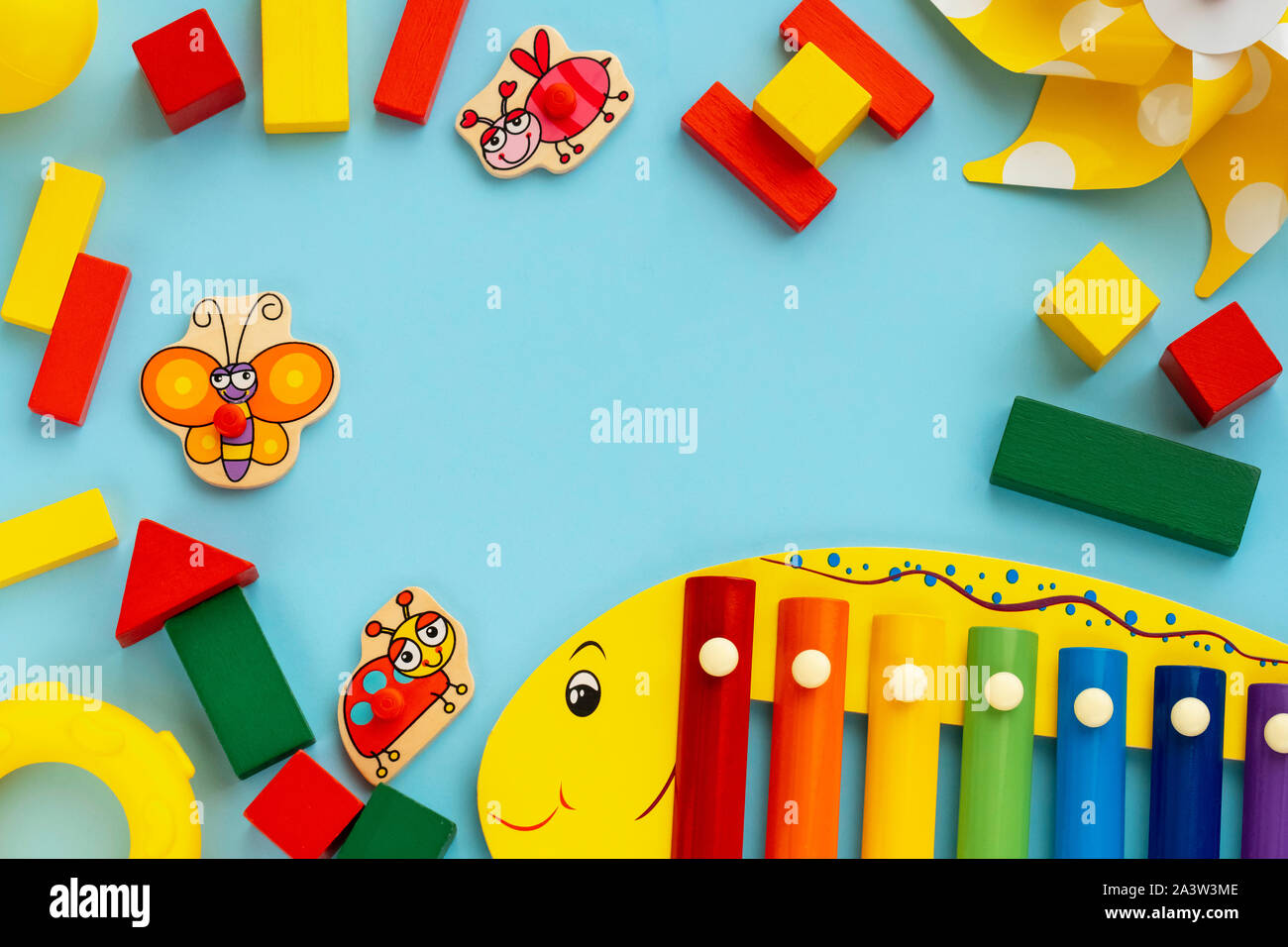 Top view on children's educational and music games, frame from multicolored  kids toys on light blue paper background. Wooden cubes, stars, circles  Stock Photo - Alamy