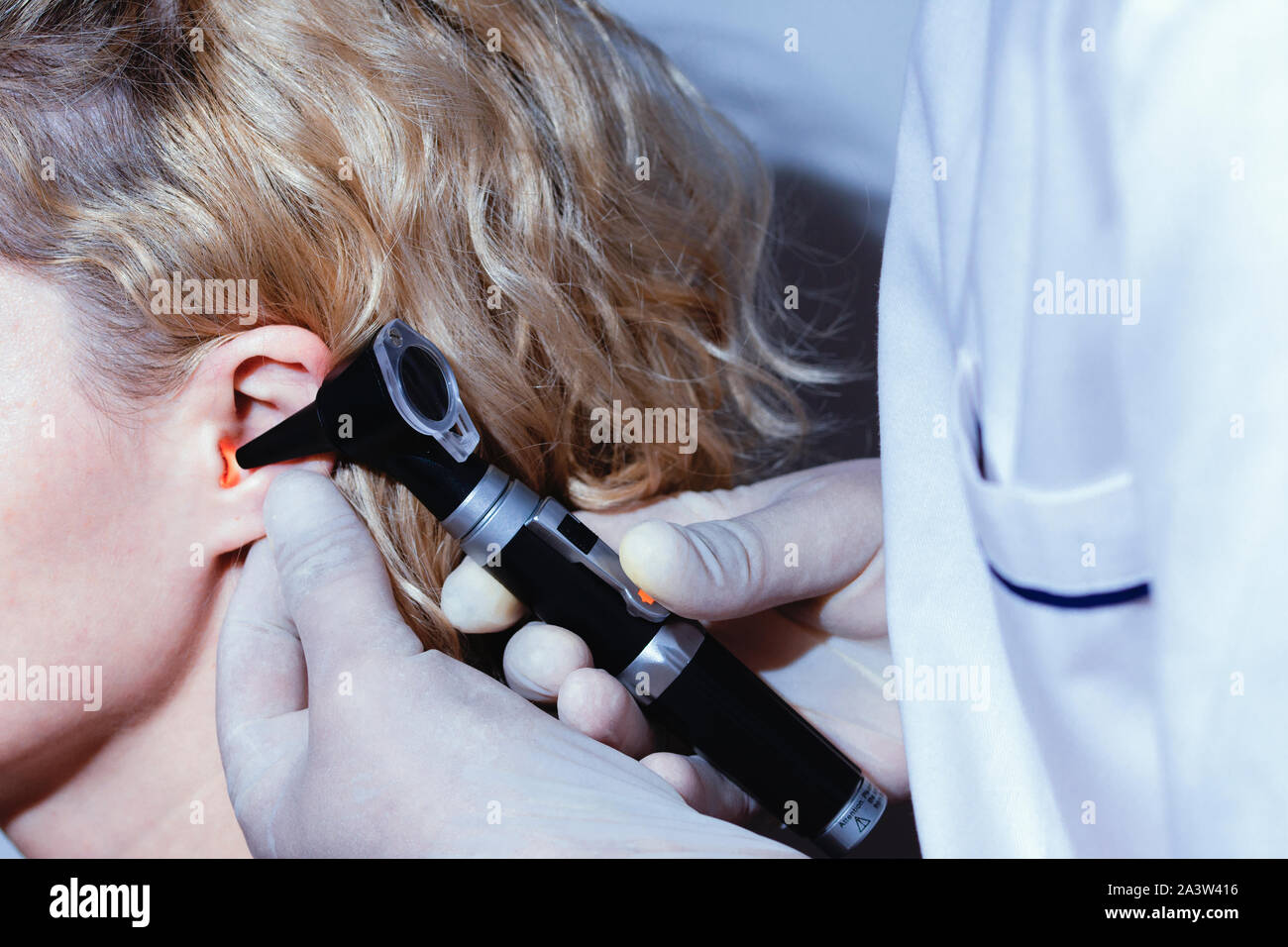 Doctor examining patient ear hi-res stock photography and images - Alamy