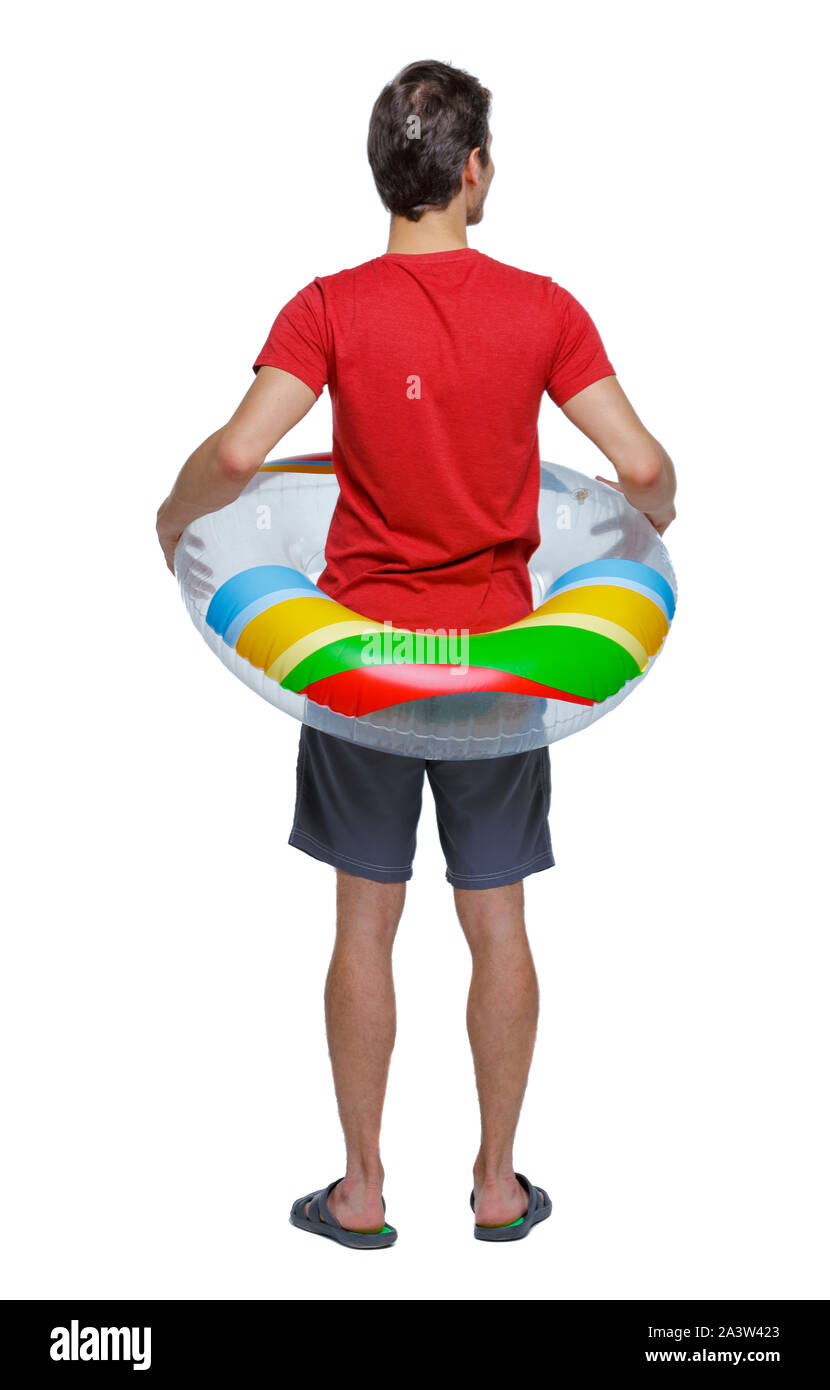 Back view of a man in shorts with an inflatable circle. The guy on the beach. Rear view people collection. backside view of person. Isolated over whit Stock Photo