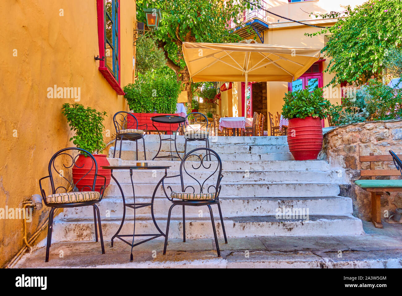 Charming street cafe on the stairs in Plaka district in Athens, Greece Stock Photo