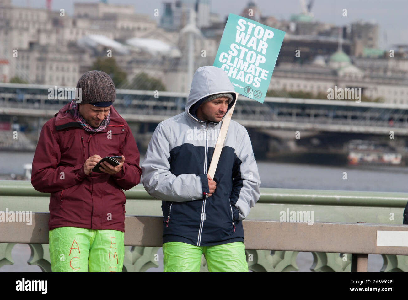 Extinction Rebellion protests, protester with Stop war stop climate chaos, banner on Westminster bridge Stock Photo