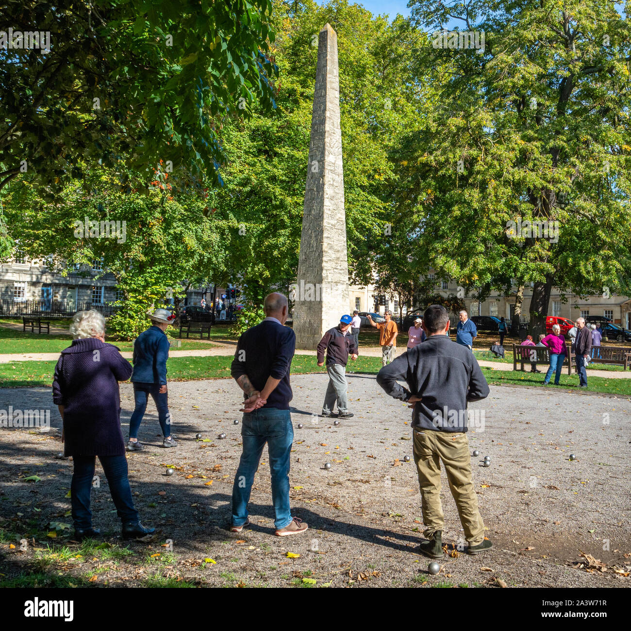 Playing a relaxing game of Boules or Petanque by the obelisk at Queen Square Bath UK Stock Photo