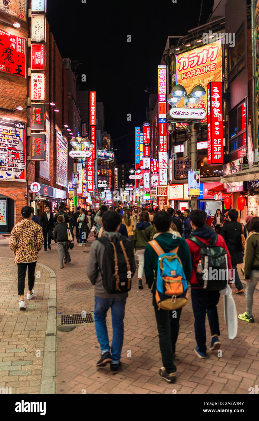 Tokyo city lights. People walking along the streets of  the famous entertainment district of Shibuya Stock Photo