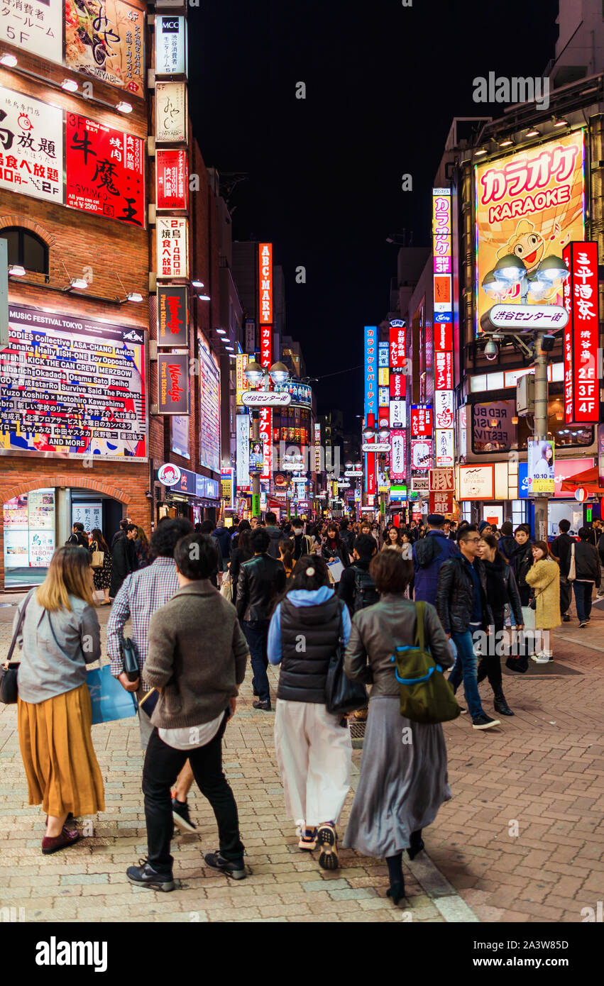 Tokyo city lights. People walking along the streets of  the famous entertainment district of Shibuya Stock Photo