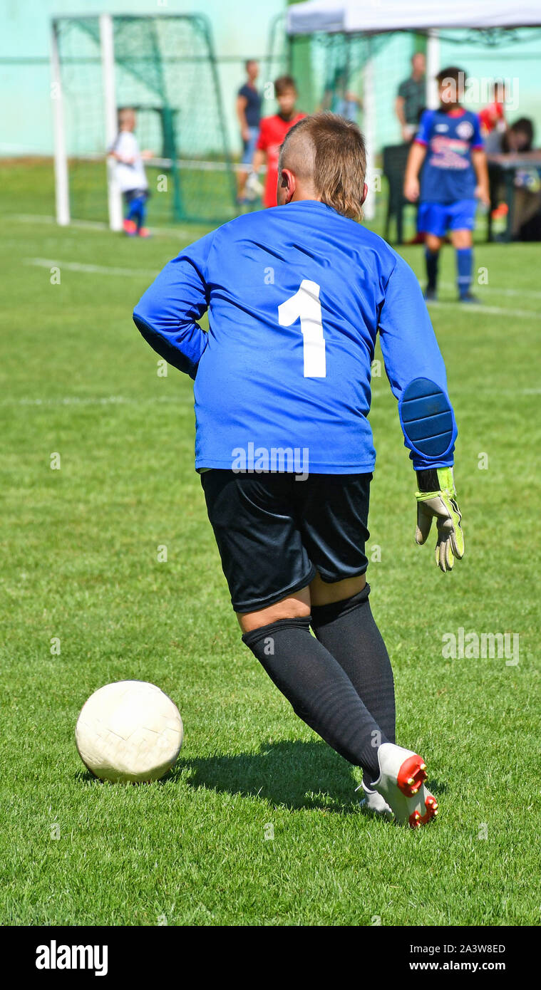 Young goalkeeper kicks the ball out Stock Photo Alamy