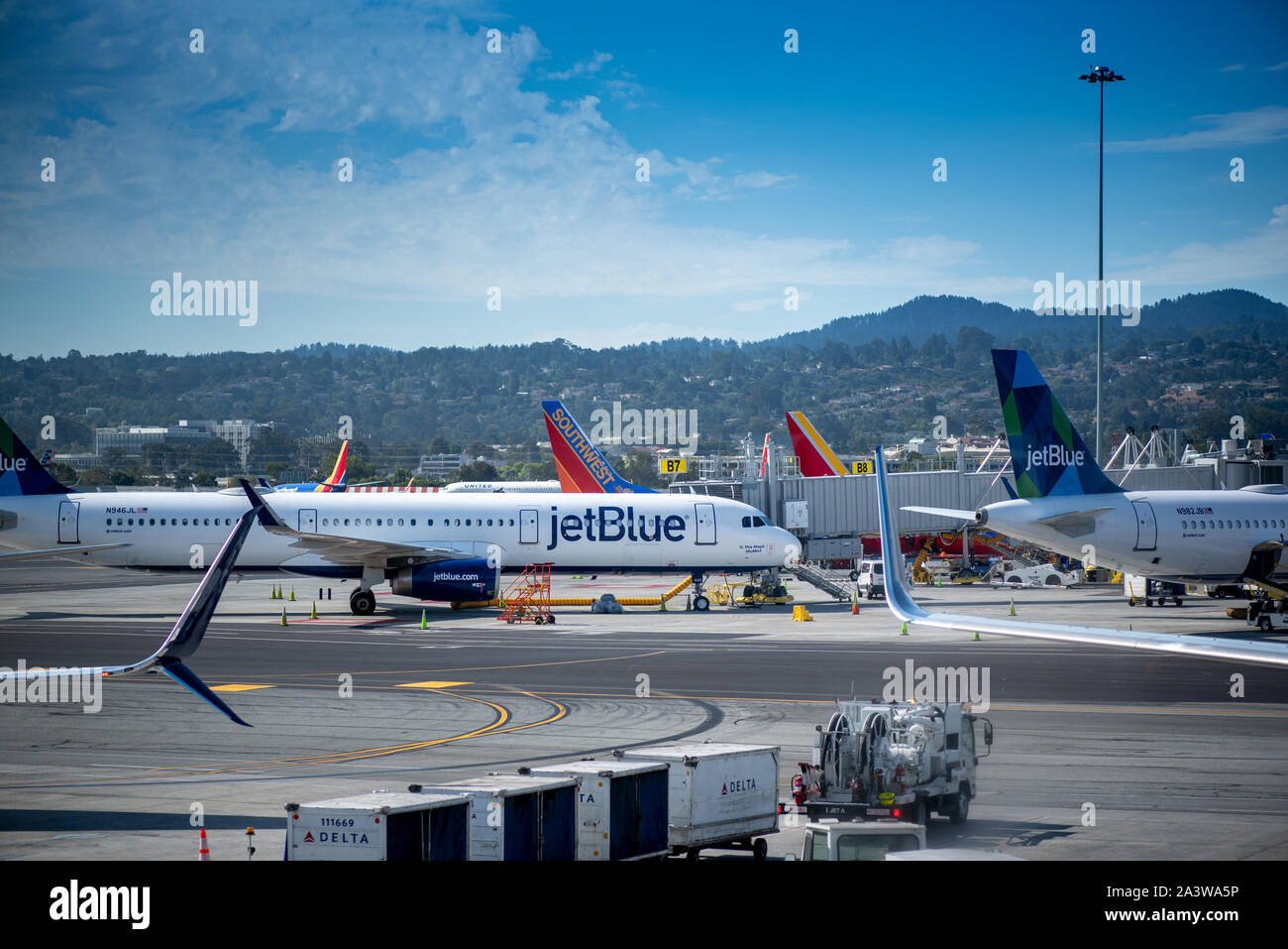 San Francisco, CA- September 4, 2019: Jet Blue airplane ready for boarding, viewed from the glass window of an airport in the Unitd States. JetBlue Ai Stock Photo