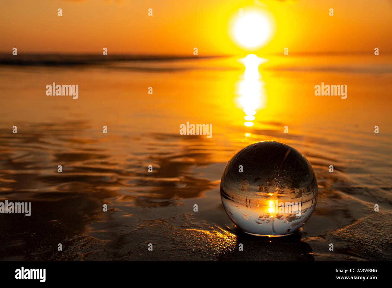 A beautiful sunset seen trough a little lensball. I captured this picture at a beach in a small city in Bali, Indonesia. Stock Photo