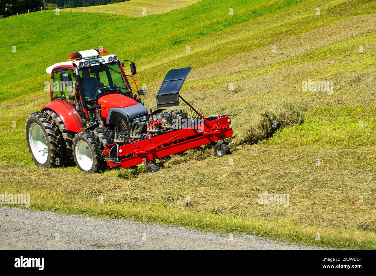Tractor in the field , Hohe Salve mountain, Soll, Austrian Alps Stock Photo