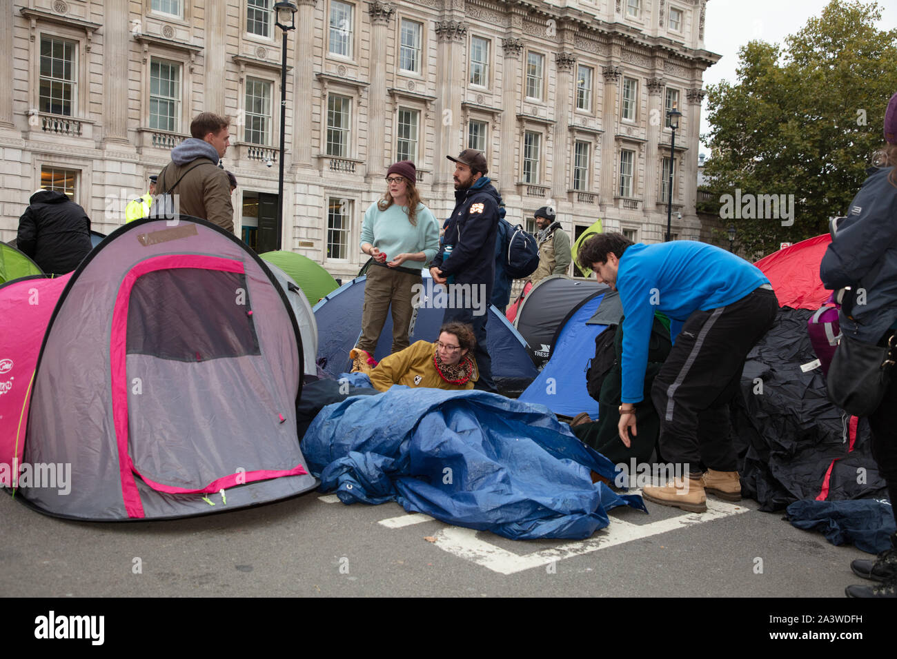 London, UK. 9th October 2019. Demonstrators seen near Downing Street in the early morning, during the Extinction Rebellion two week long protest in London. Credit: Joe Kuis / Alamy News Stock Photo