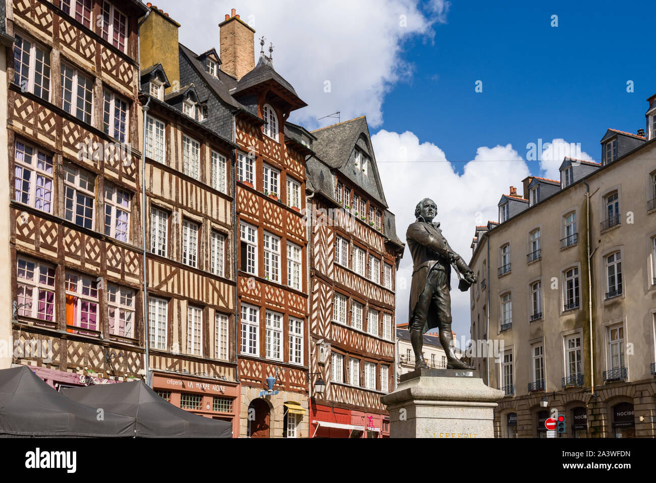 statue of Leperdit and traditional half-timbered houses on Champ ...