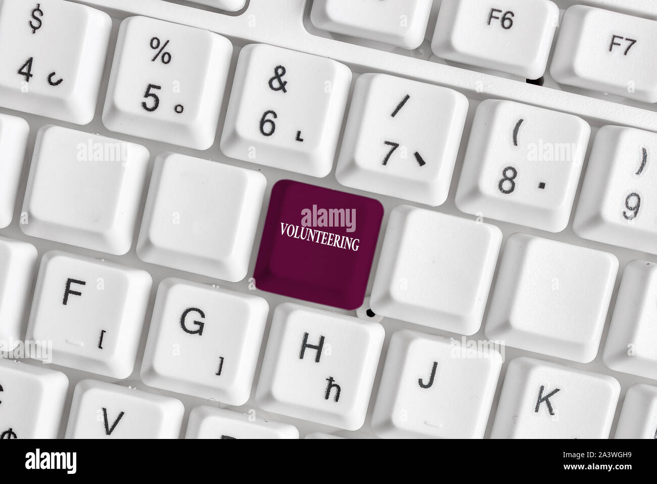 Text sign showing Volunteering. Business photo text Provide services for no  financial gain Willingly Oblige White pc keyboard with empty note paper ab  Stock Photo - Alamy