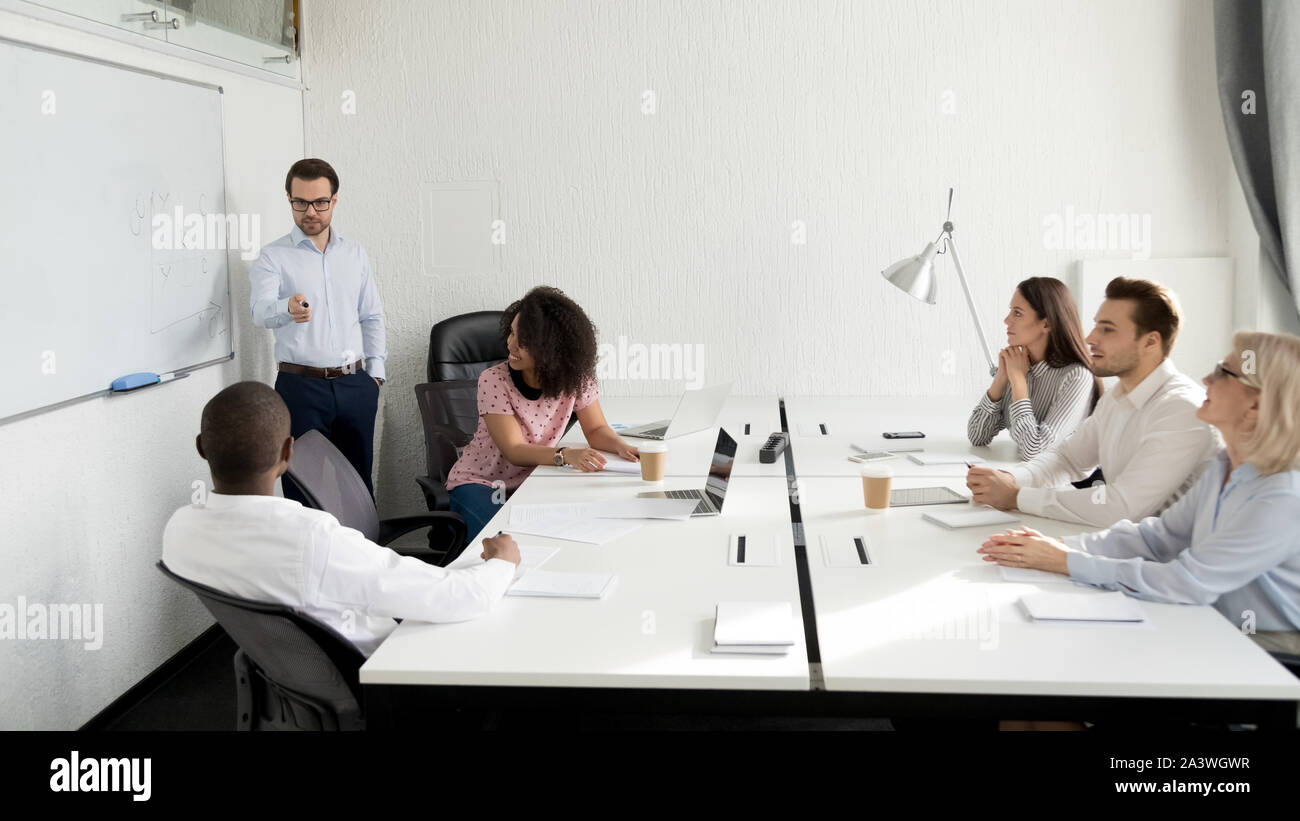Male business coach giving presentation to diverse company staff Stock ...