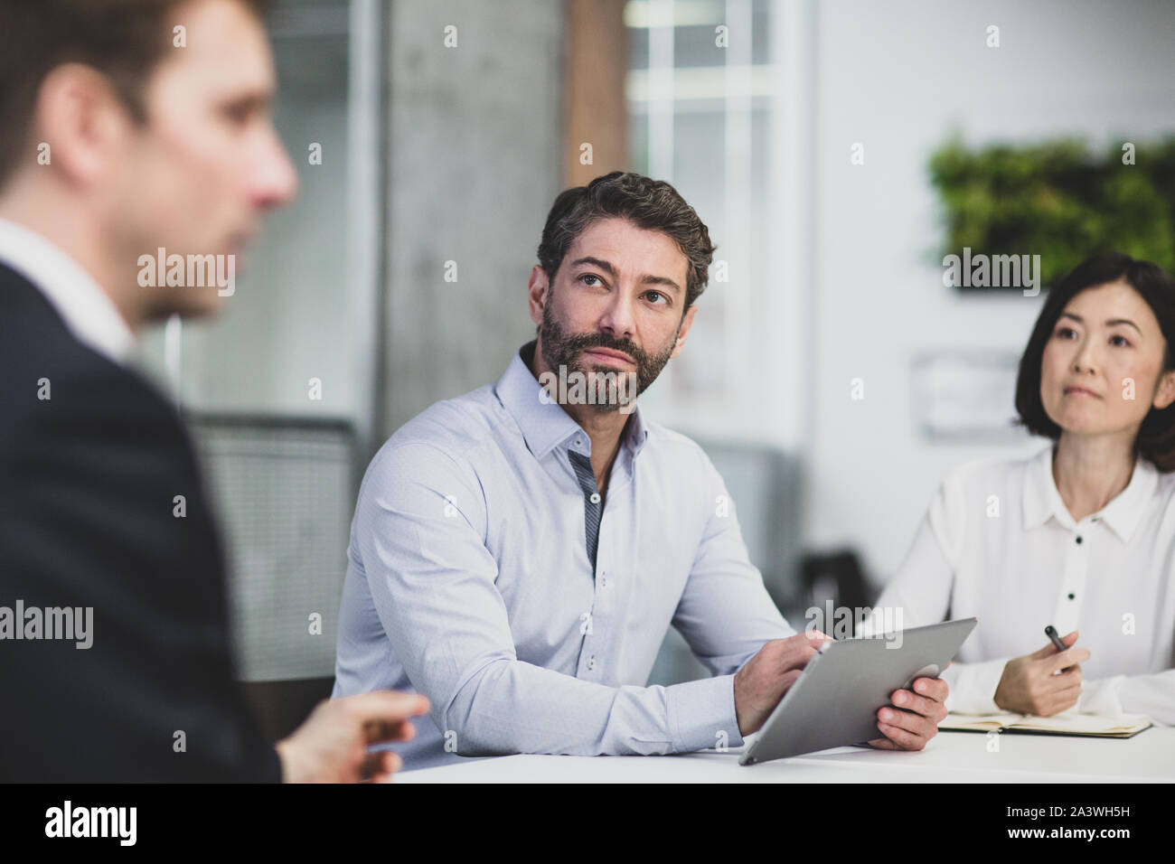 Corporate business executives listening in a board meeting Stock Photo