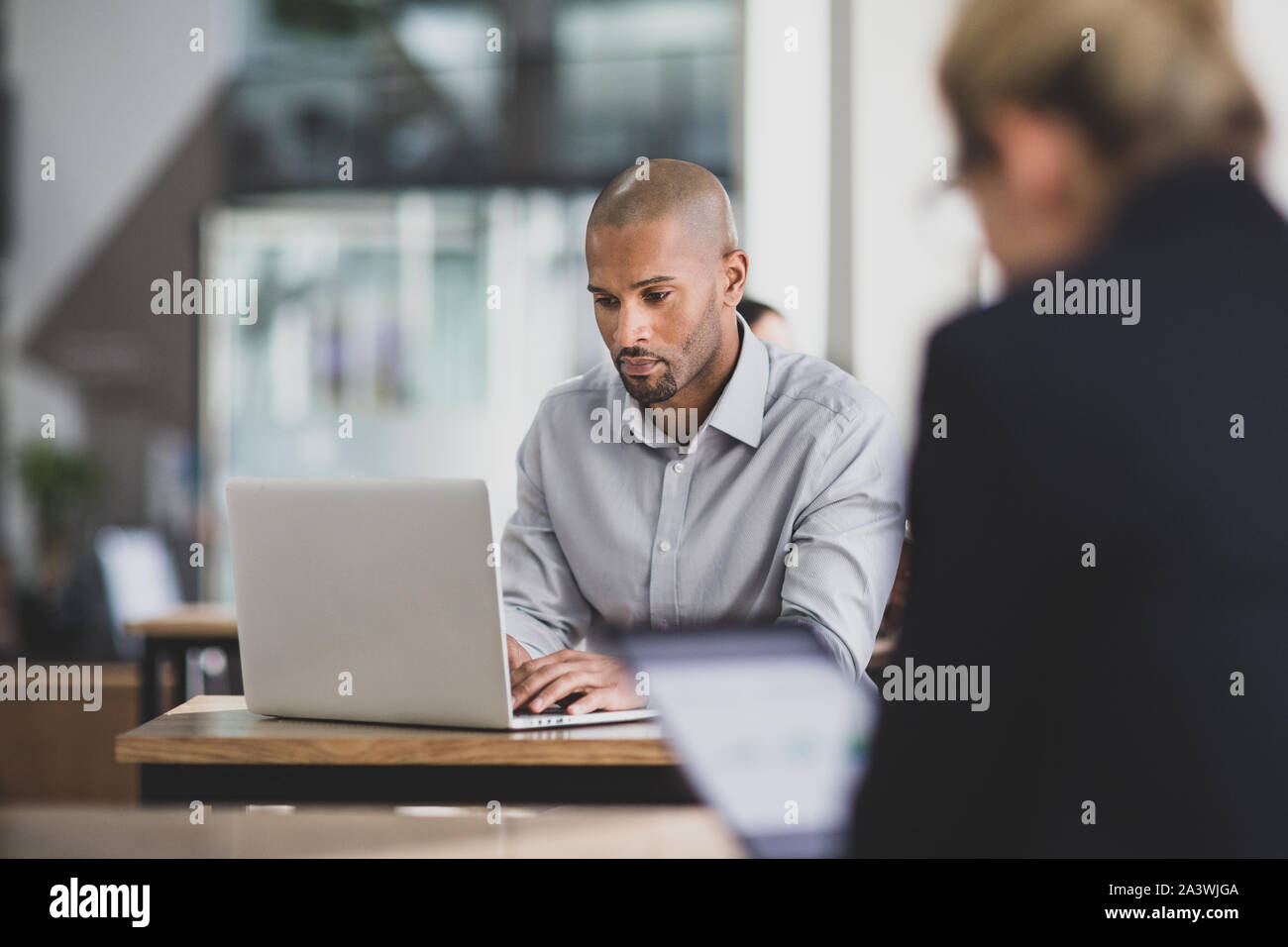 Businessman in a cafÃ© using a laptop Stock Photo