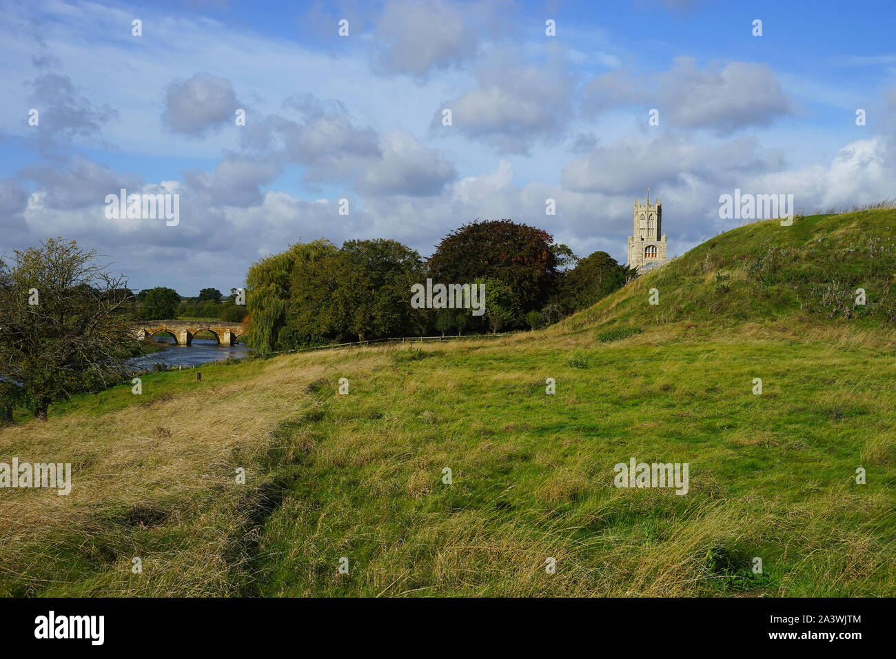 The Church, the bridge over the River Nene and the castle motte at Fotheringhay Stock Photo
