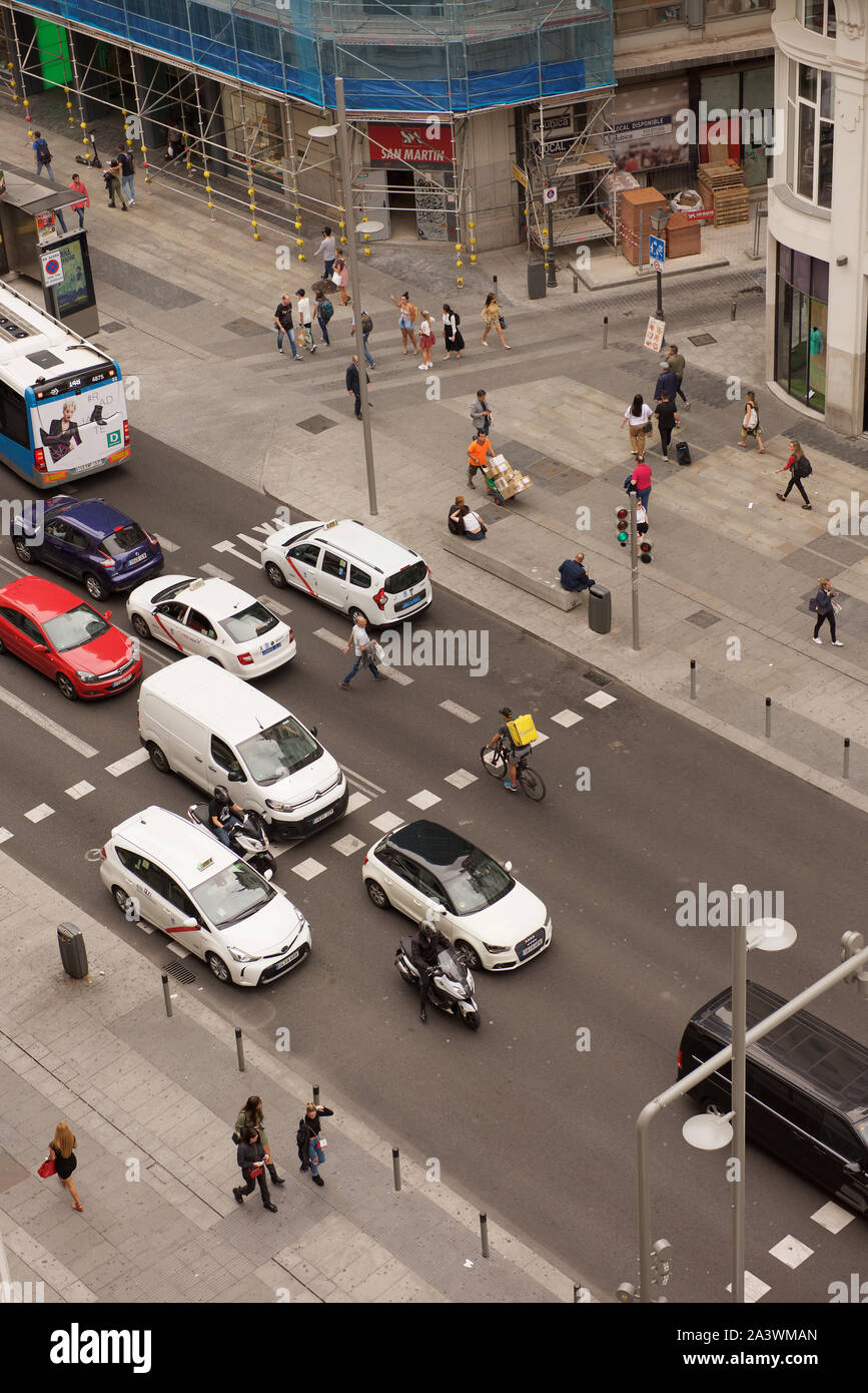 Traffic and pedestrians on a busy street Stock Photo