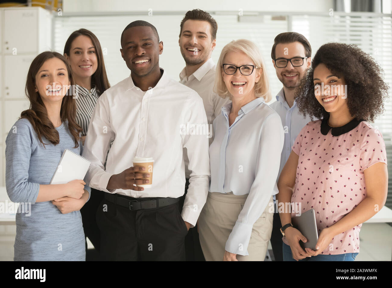 Positive multi racial corporate team posing looking at camera Stock Photo