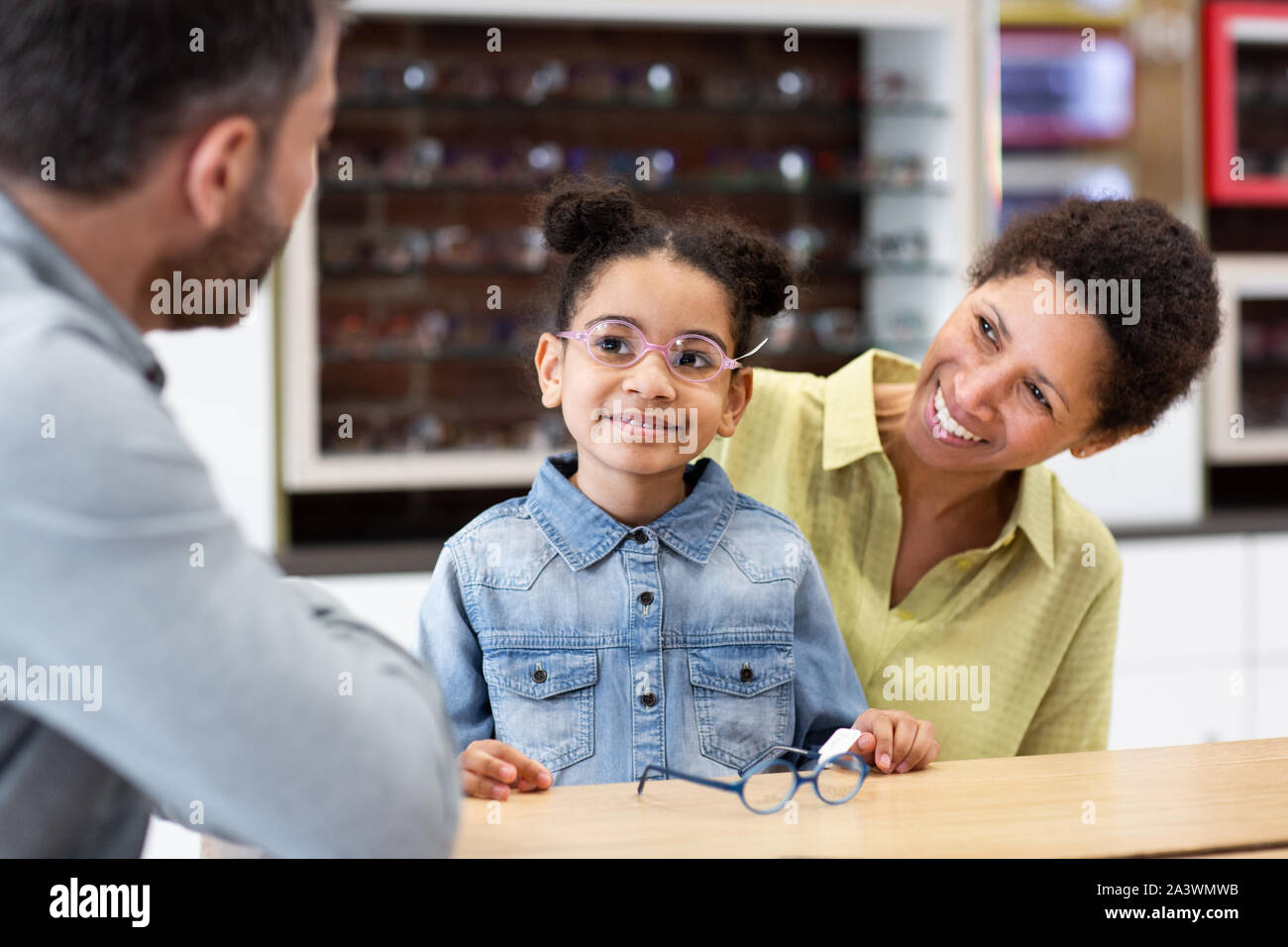 Young girl with new glasses at the opticians Stock Photo