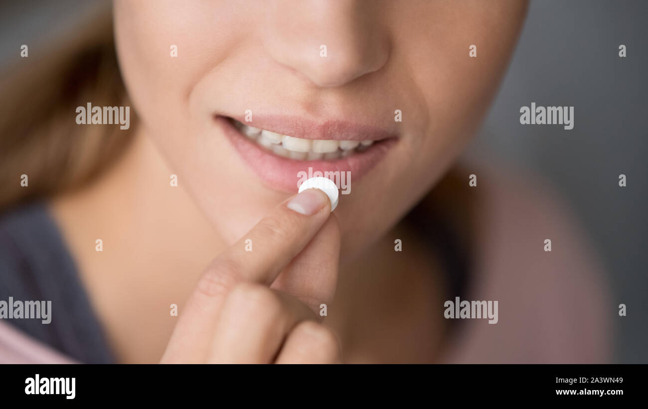 Young woman holding pill take meds, close up view Stock Photo
