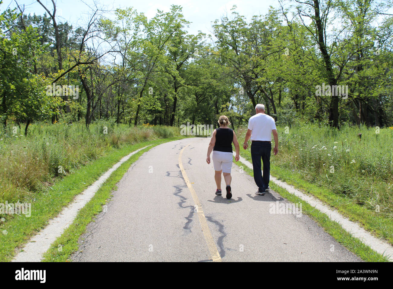 Older couple walking on the North Branch Trail at Miami Woods in Morton Grove, Illinois Stock Photo