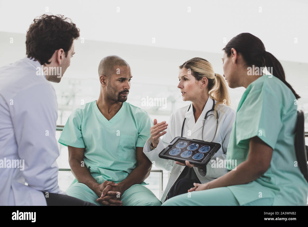 Medical professionals discussing patient treatment in a hospital Stock Photo