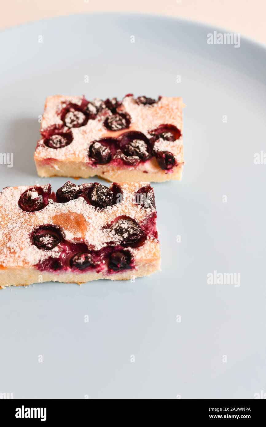 cottage cheese pie with berries. eating with a spoon. view from above.  Stock Photo