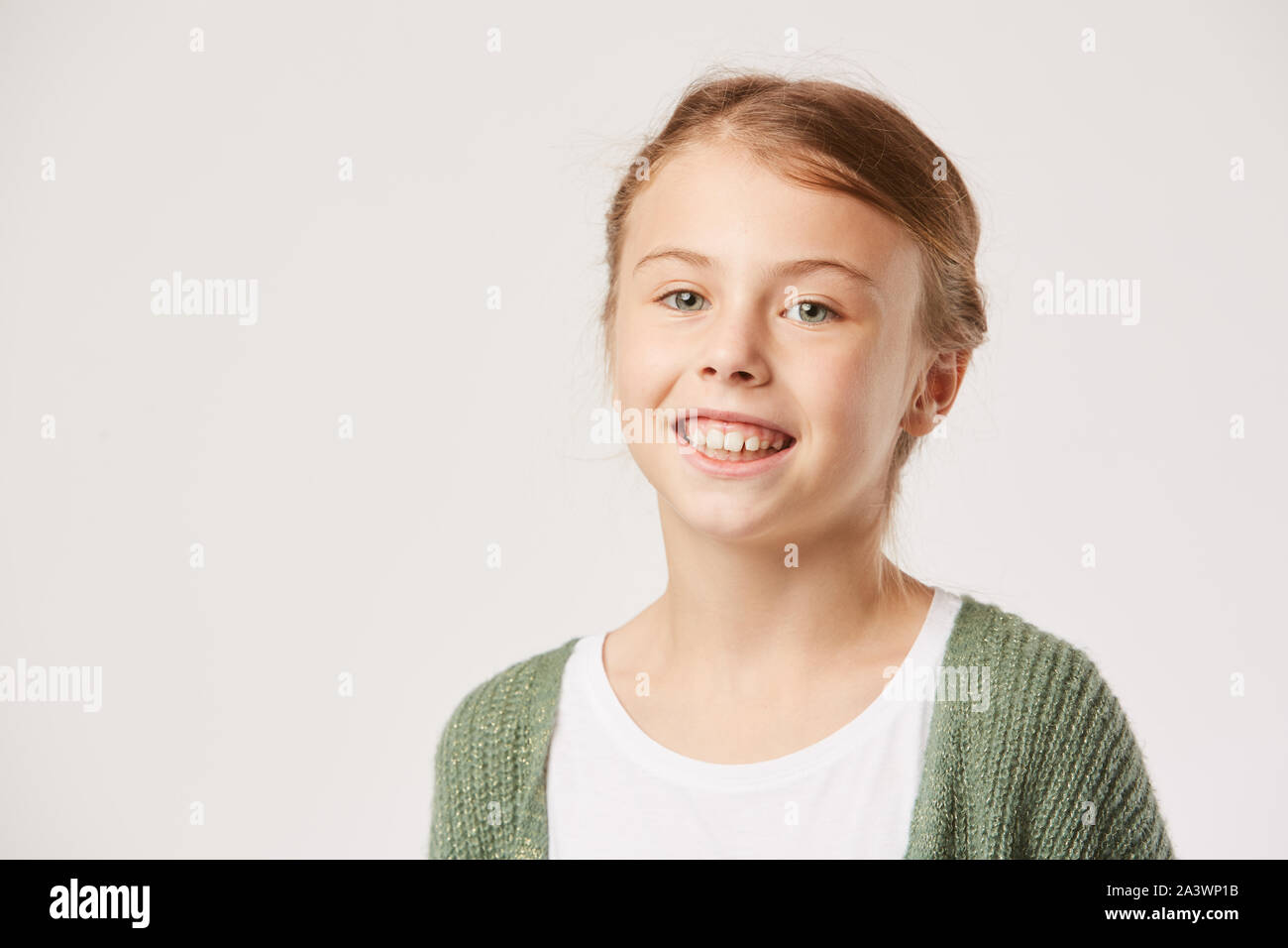 Portrait of happy little girl smiling at camera isolated on white ...