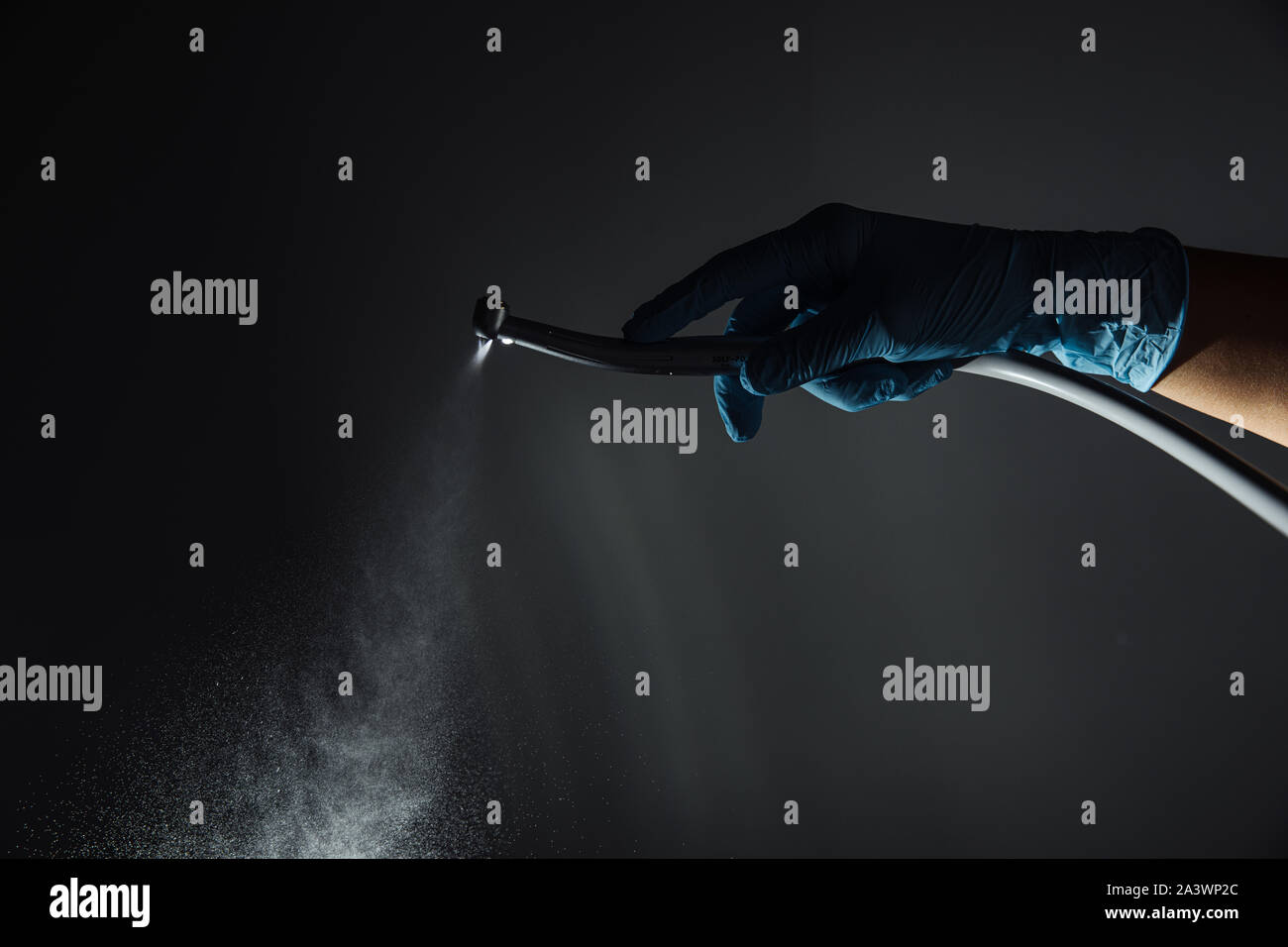 Dentist hand with drill illustrates the operation of the dentist dental