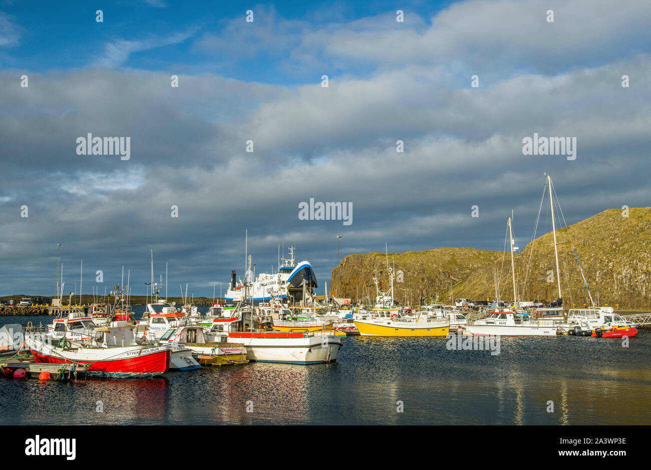 The harbour at Stykkisholmur on the Snaefellsness Peninsula in Iceland showing the ferry boat to the Western Fjords in the background. Stock Photo