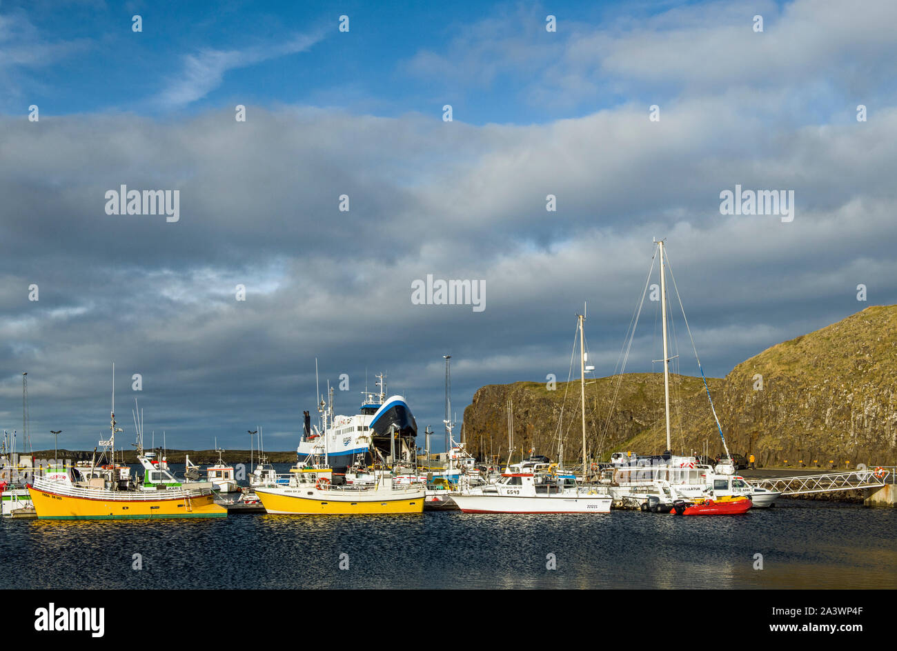 The harbour at Stykkisholmur on the Snaefellsness Peninsula in Iceland showing the ferry boat to the Western Fjords in the background. Stock Photo