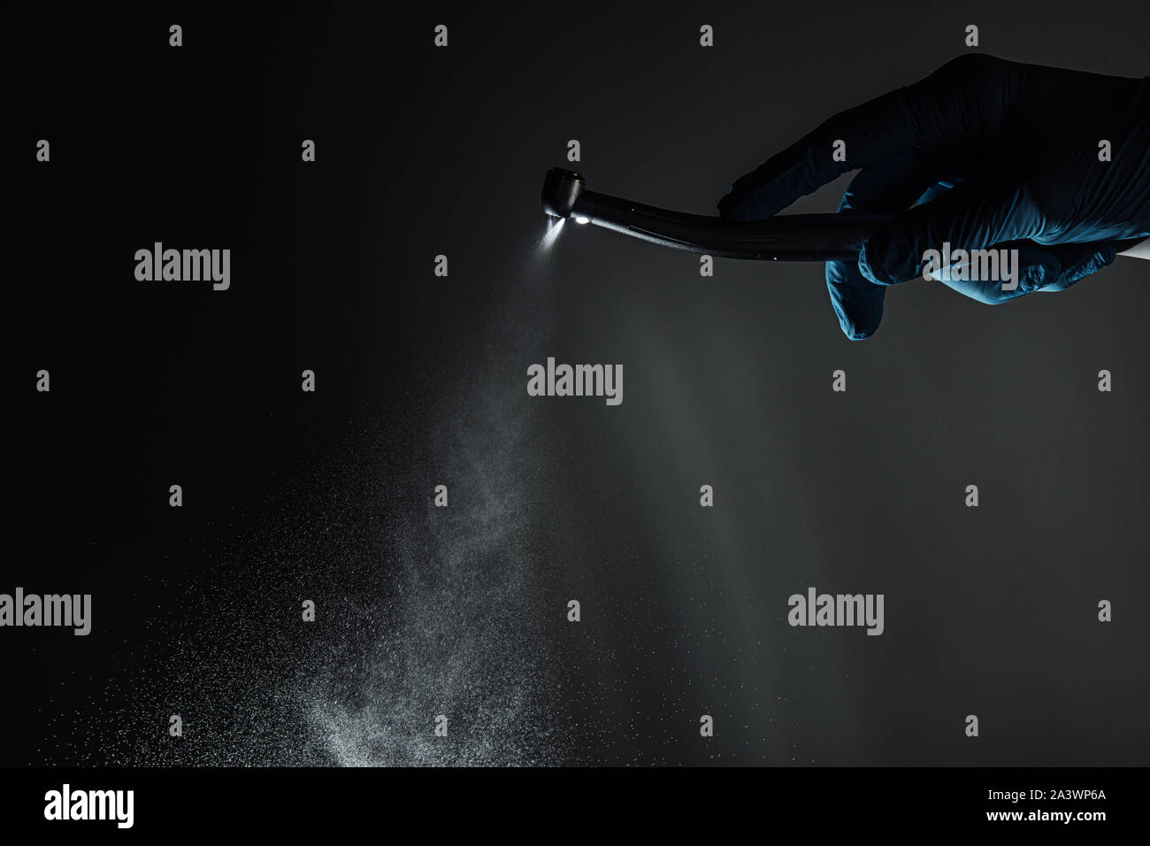 Dentist hand with drill illustrates the operation of the dentist dental