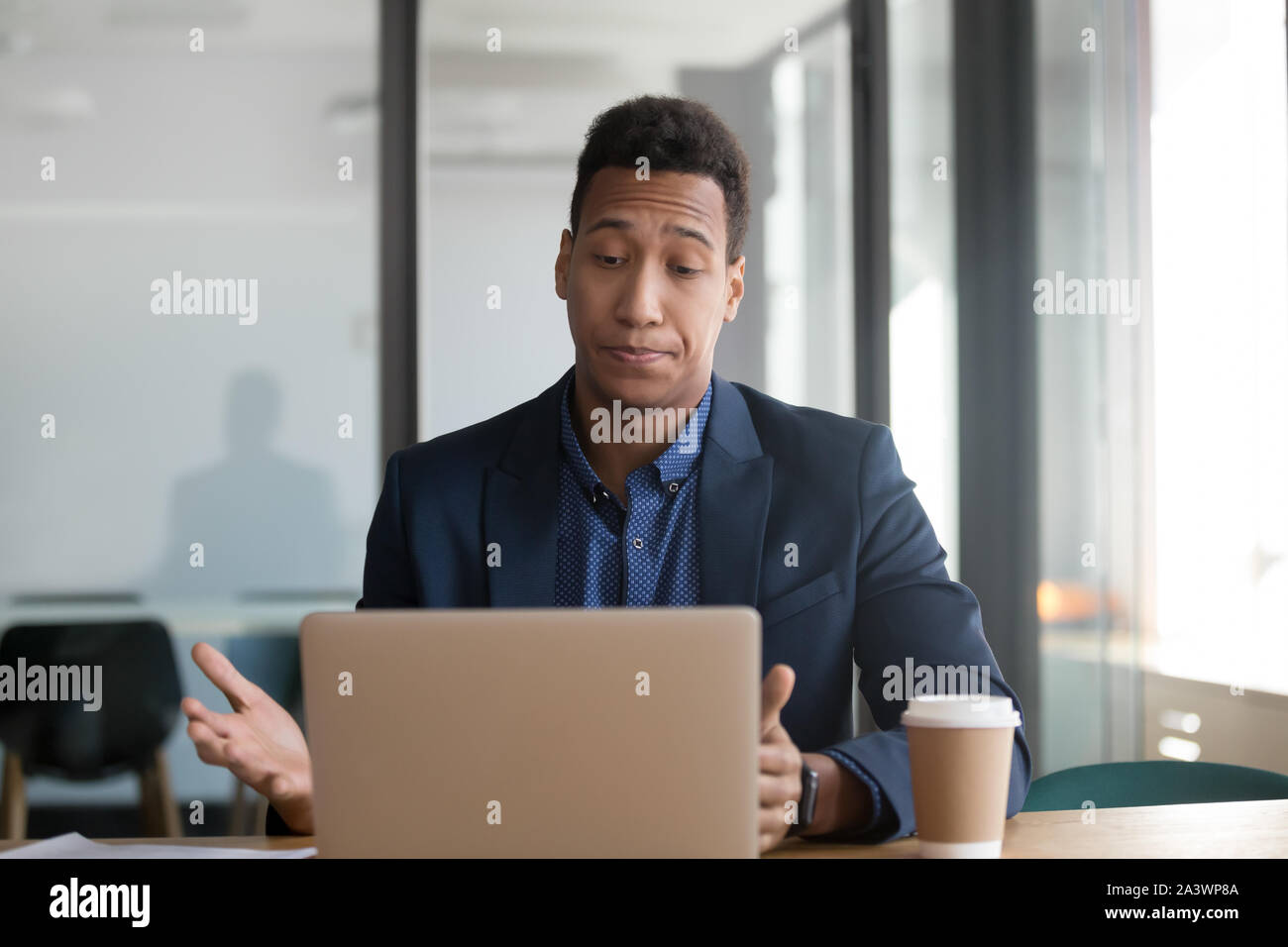 Stressed annoyed african black business man using stuck slow laptop Stock Photo
