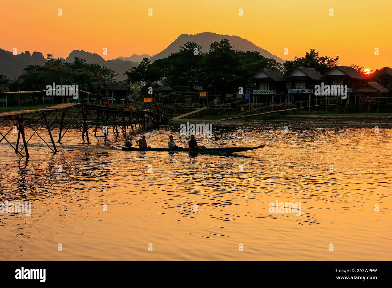 Sunset over Nam Song River in Vang Vieng, Laos. Vang Vieng is a popular destination for adventure tourism in a limestone karst landscape. Stock Photo
