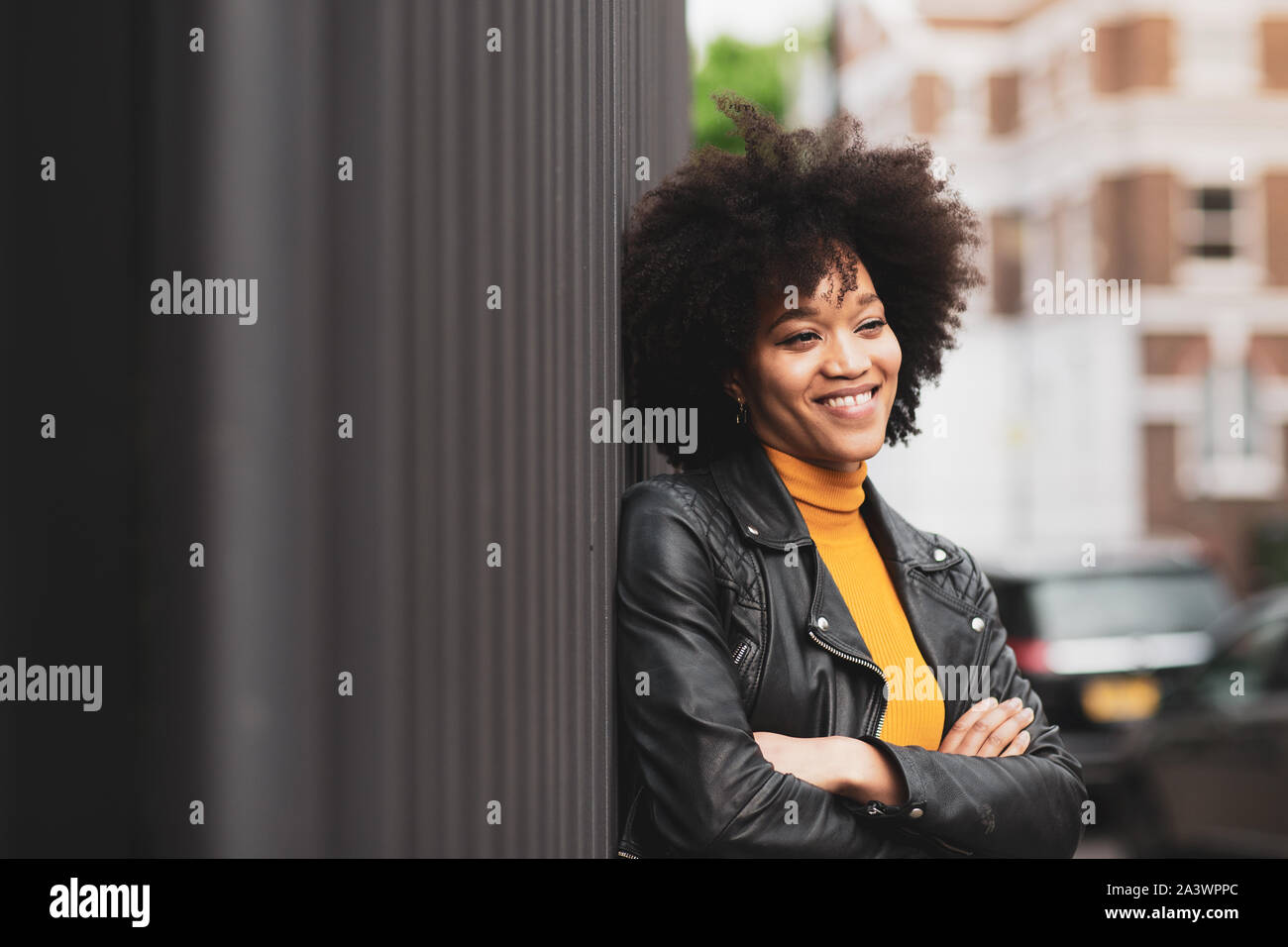 African American young adult female in city in summer Stock Photo