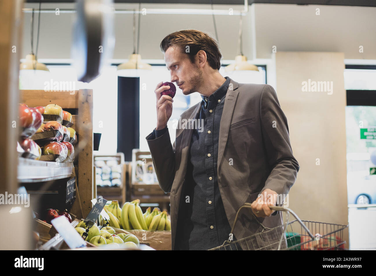 Male shopper buying apples in a grocery store Stock Photo