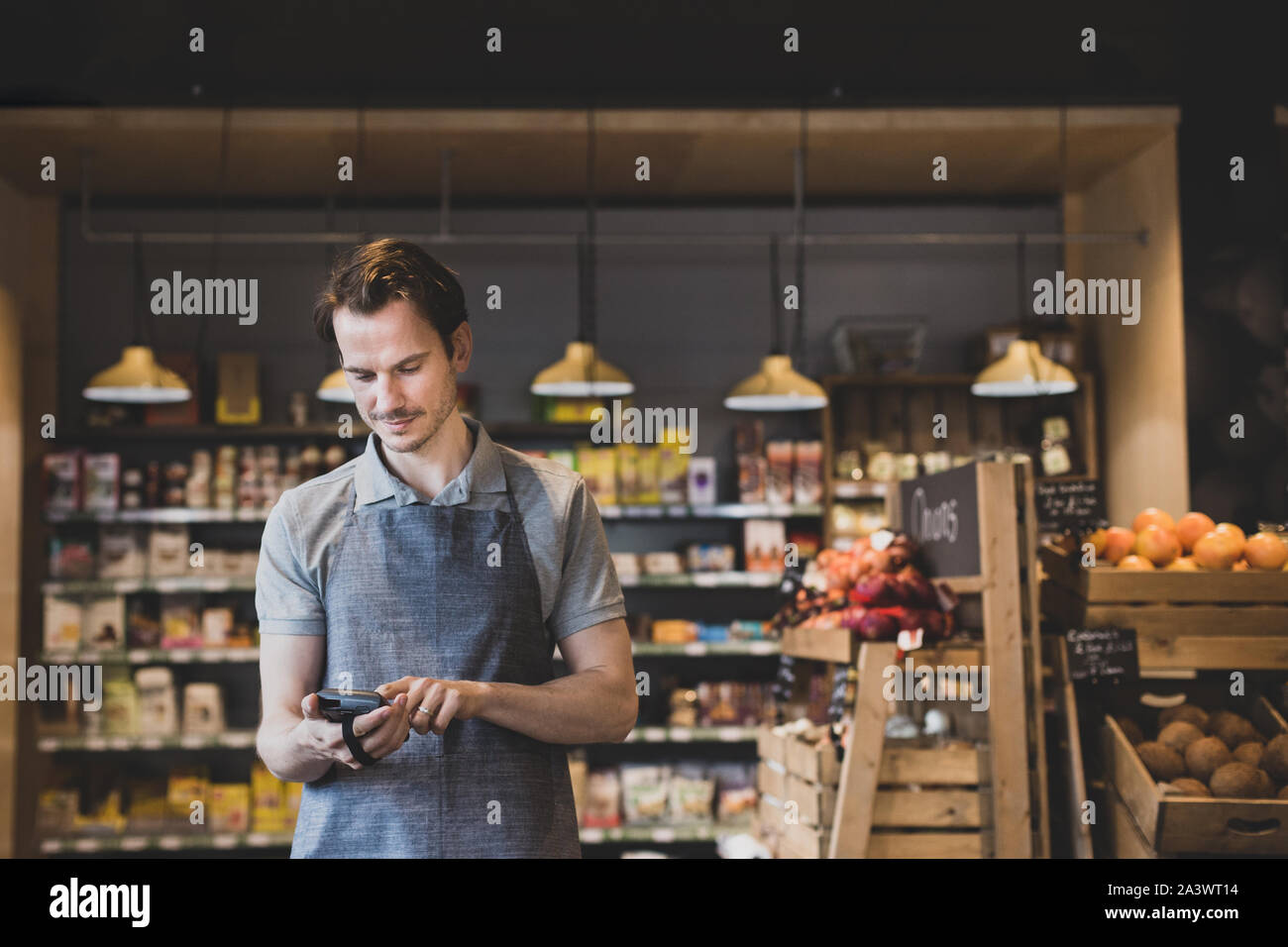 Sales assistant in food market using a scanner Stock Photo