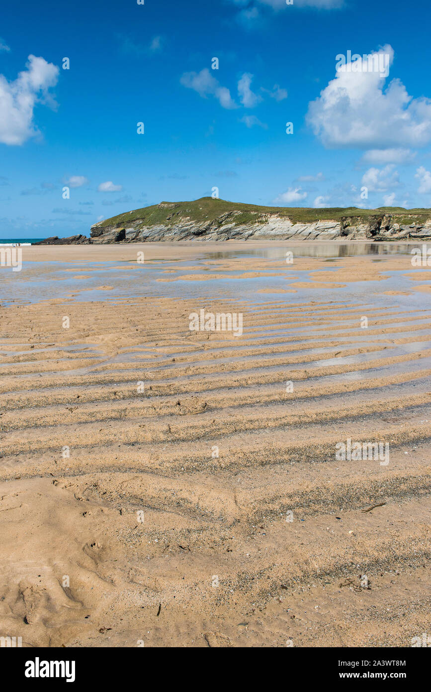 Low tide at Porth Beach with Porth Island Trevelegue Head in the background in Newquay in Cornwall. Stock Photo