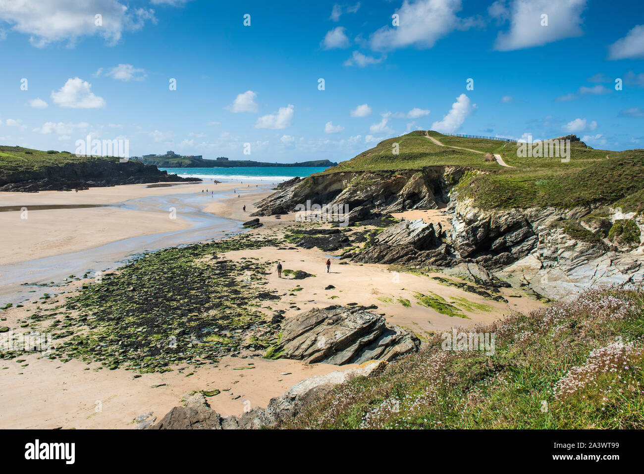 A spring tide exposes the rocks at Porth Beach in Newquay in Cornwall