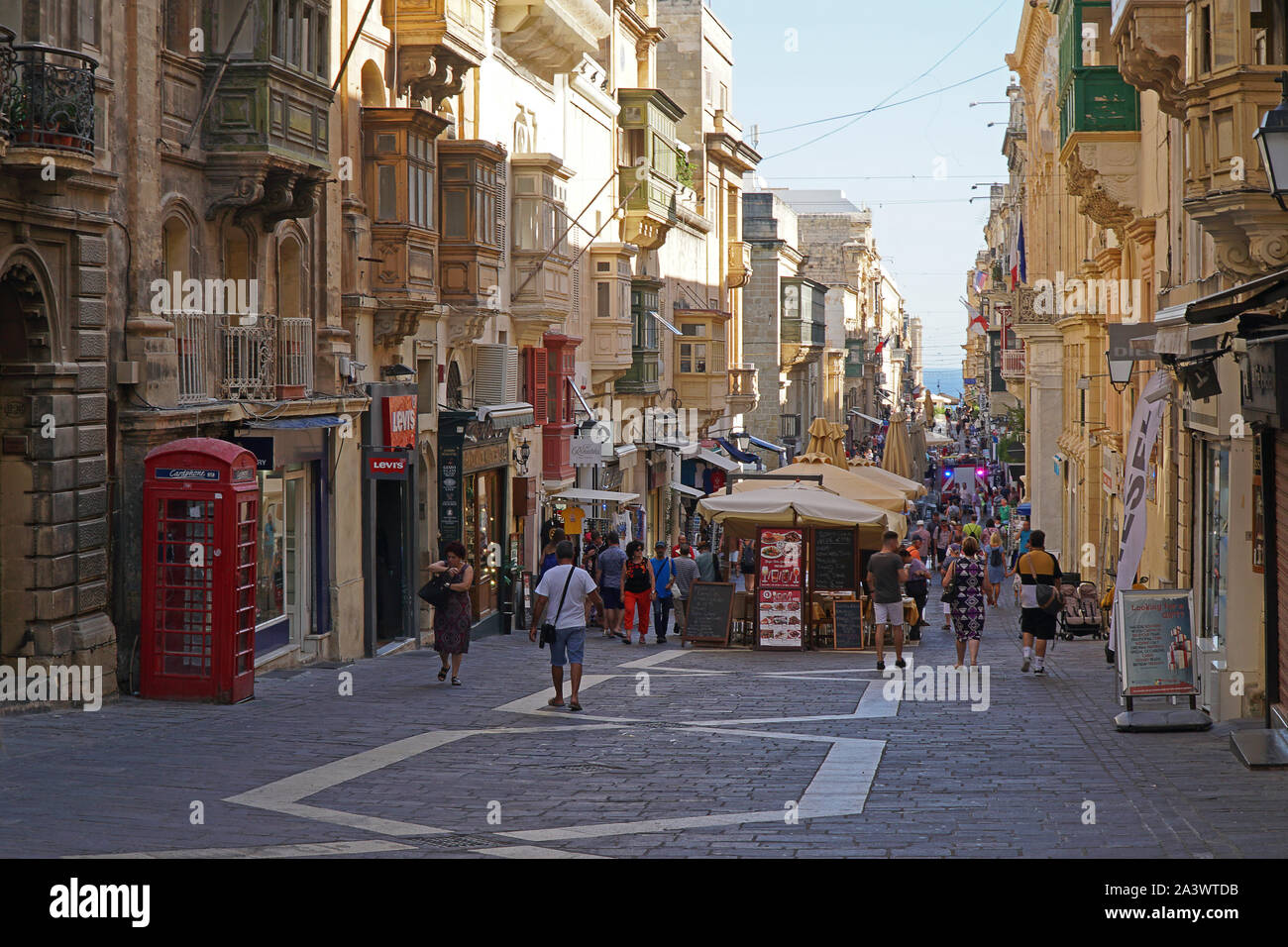 A shop lined street in Valletta, Malta Stock Photo