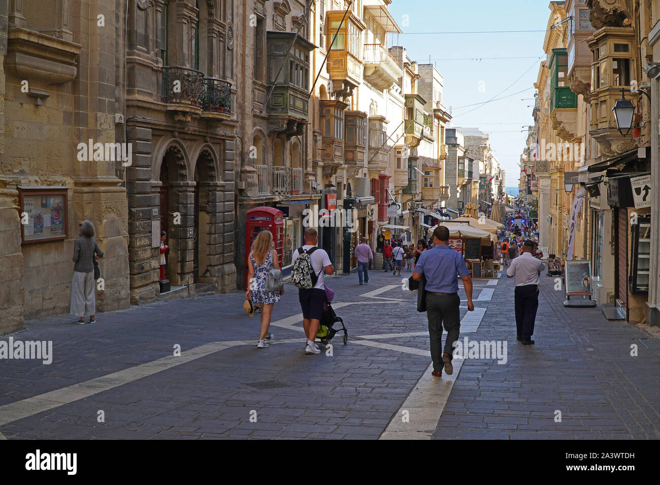 A shop lined street in Valletta, Malta Stock Photo